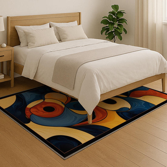 Modern abstract chenille rug with fluid shapes in navy, orange, golden yellow, and beige, washable with non-slip recycled cotton backing.