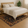 Aztec-inspired chenille rug with oriental influence, navy background, red and gold tribal geometric motifs, washable non-slip backing, perfect for boho and rustic decor.