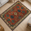 Aztec-inspired chenille rug with oriental influence, rust red background, blue and cream tribal diamond motifs, washable non-slip backing, perfect for boho and rustic decor.